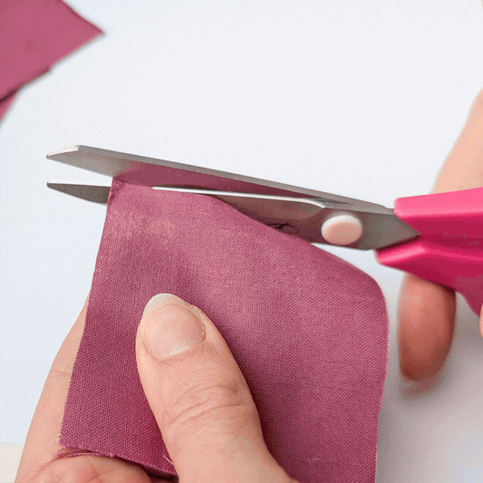 Madam Sew Medium Fabric Scissors cutting a variety of fabrics, trims and button.