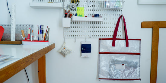 Project bag hanging on a pegboard with sewing supplies in the background