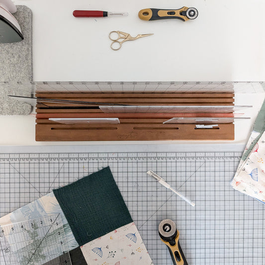 View from above showing rulers in the Madam Sew Quilting Ruler Holder on a cutting table.