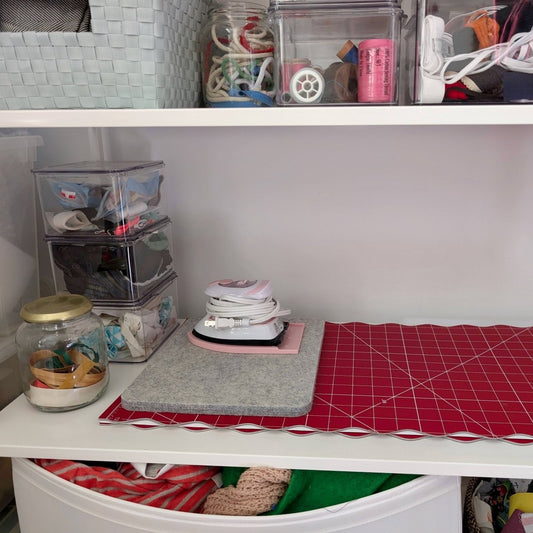 Madam Sew Self Healing Cutting Mat folded on shelf with sewing tools and notions