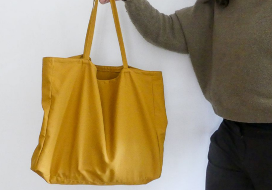 women holding a yellow handmade tote bag