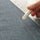 Detail of the chalk wheel of a white chalk marker with two thin lines drawn on fabric and a ruler