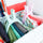 Two clamps holding fabric pieces in a basket