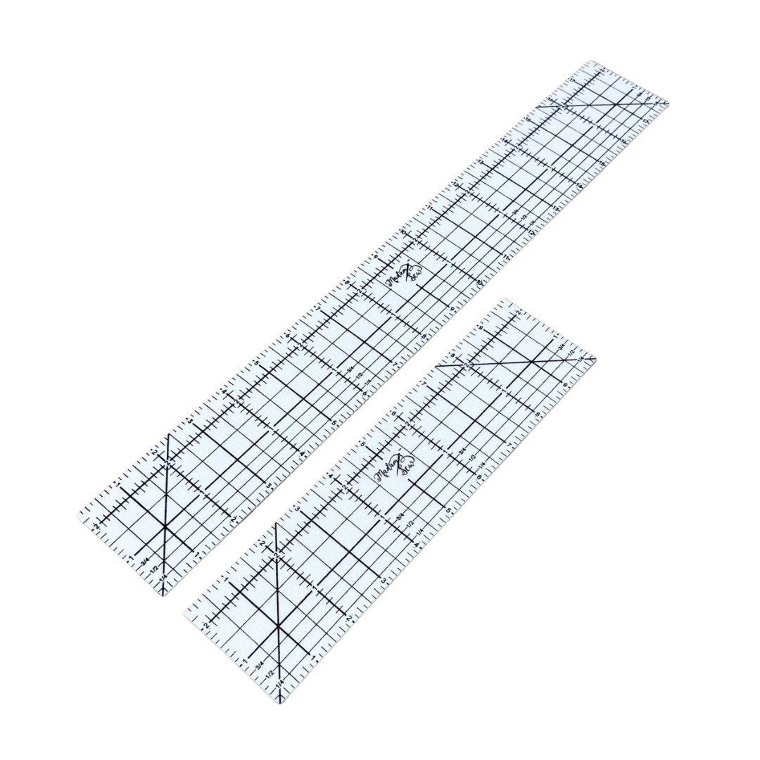 Two hot hem rulers, one 18 inches long and one 10 inches on a white background