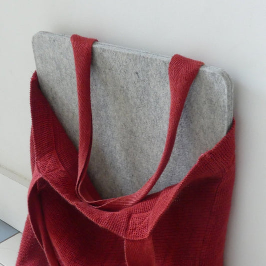 A wool pressing mat in a tote bag