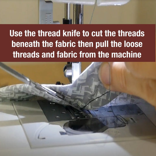 cutting a thread that is bunched up under the needle of a sewing machine