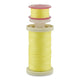a spool with yellow thread, a bobbin with yellow thread, held together with a bobbin holder
