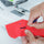 Cutting a buttonhole open using a seam ripper.