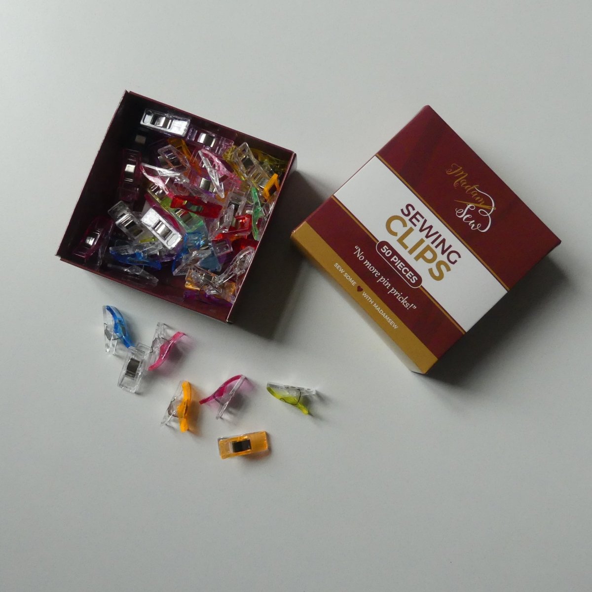 small sewing clips in a box