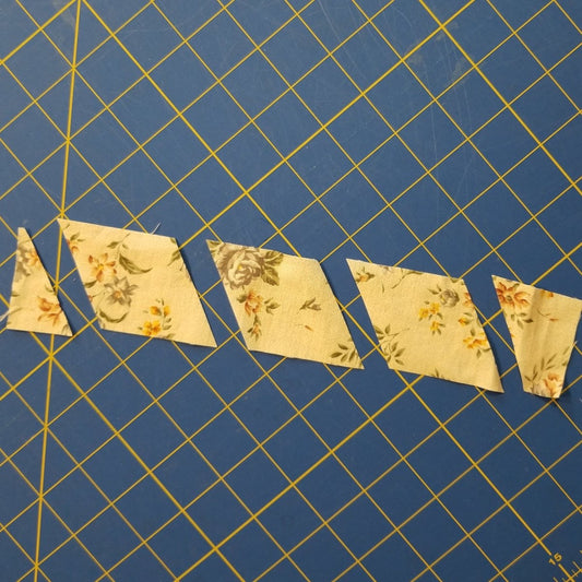 Hexagon shaped fabric pieces cut with Creative Shape Cut Ruler 6½" x 13½".