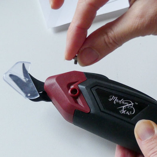 Removing screw from electric fabric scissors