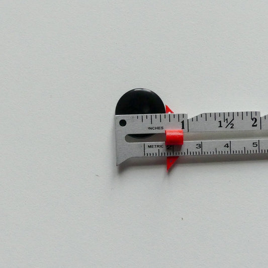 measuring a button with a measuring gauge with a slider