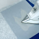 fusing HTV on a piece of fabric using a non stick pressing sheet