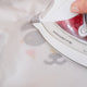 ironing on a vinyl design with a hot iron using a white pressing sheet