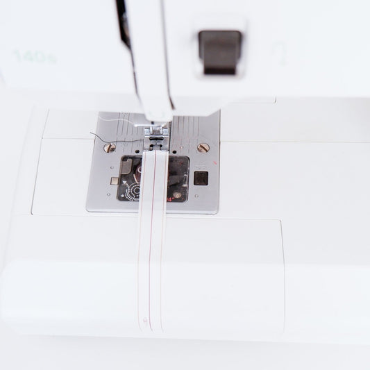 Aligning the middle line of the Quarter Inch Seam Tape with Sewing Machine Needle