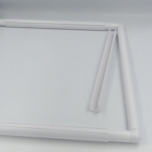 C-Shaped clamp next to a Quilt Frame.