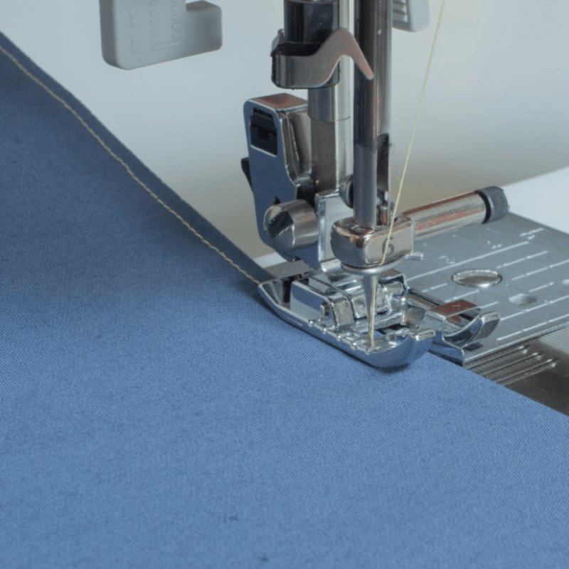 edge stitching with the edge joining foot on a sewing machine on blue fabric