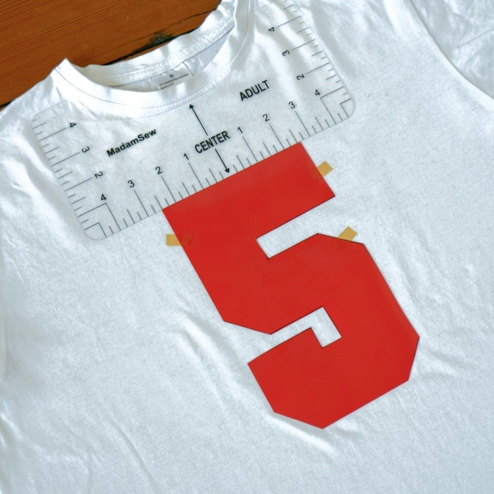 T-shirt ruler on t-shirt to position a red HTV design