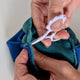 Light purple snips in use cutting seam allowance