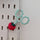 Teal snips with cover hanging up on pegboard