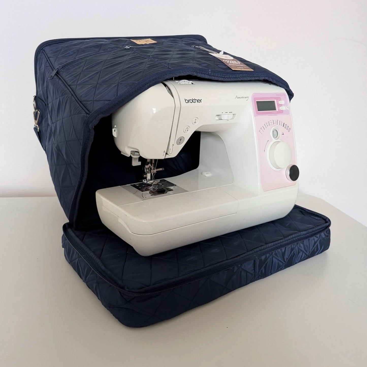 Quilted Cover & Carry sewing machine travel bag open around a sewing machine
