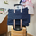 Cover & Carry sewing machine bag secured to a rolling suitcase