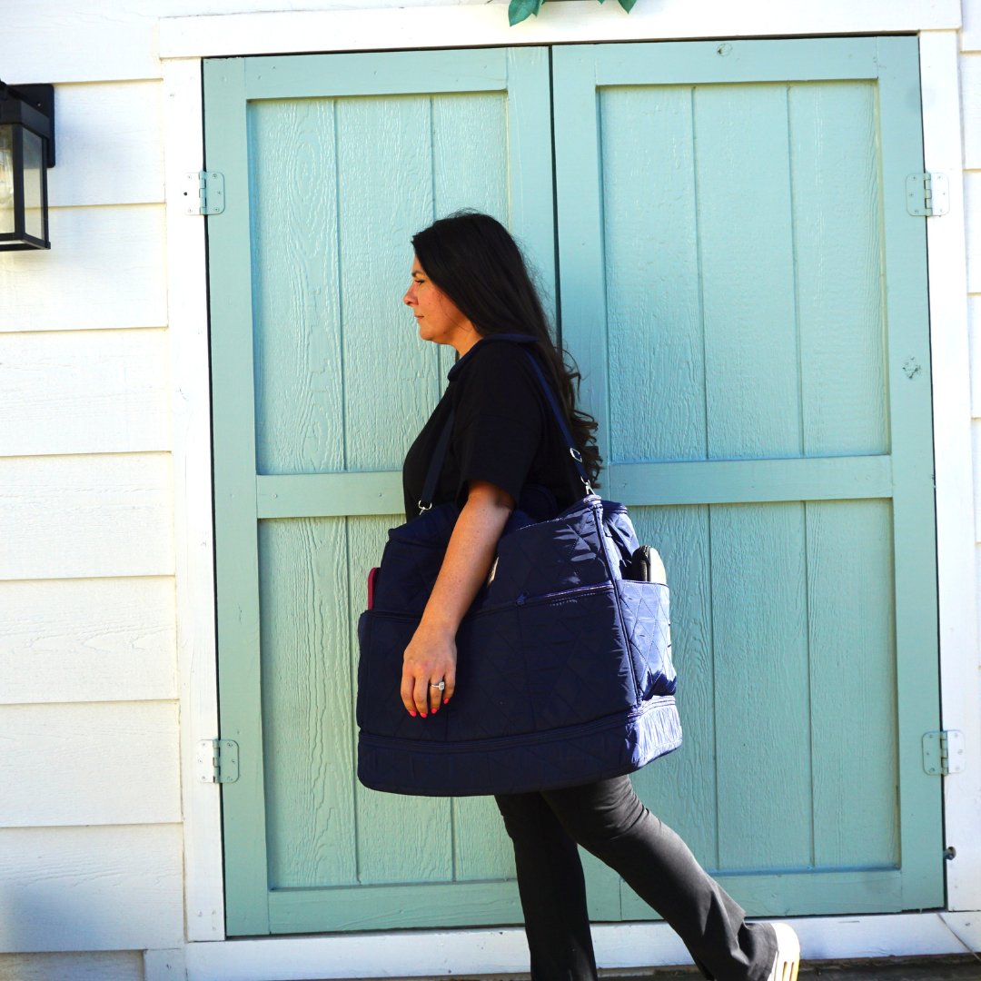 Sewist carrying a portable Cover & Carry sewing machine travel bag