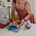 A women looking at seams while a mini iron rests on a pink mini iron rest.
