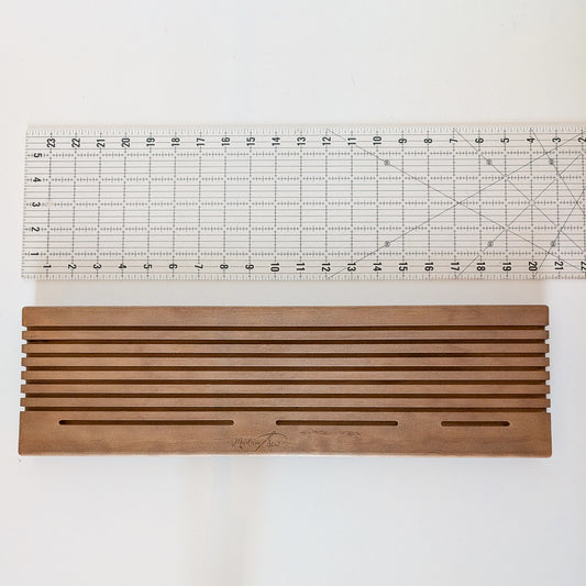 A quilting ruler showing the length of the Madam Sew Quilting Ruler Holder.