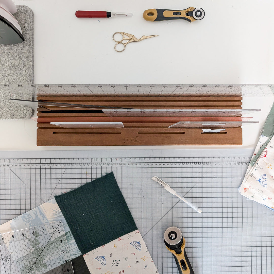 View from above showing rulers in the Madam Sew Quilting Ruler Holder on a cutting table.