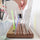 Someone reaching for a ruler in the Madam Sew Quilting Ruler Holder.
