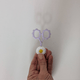Light purple snips being inserted and removed from cute daisy topper.