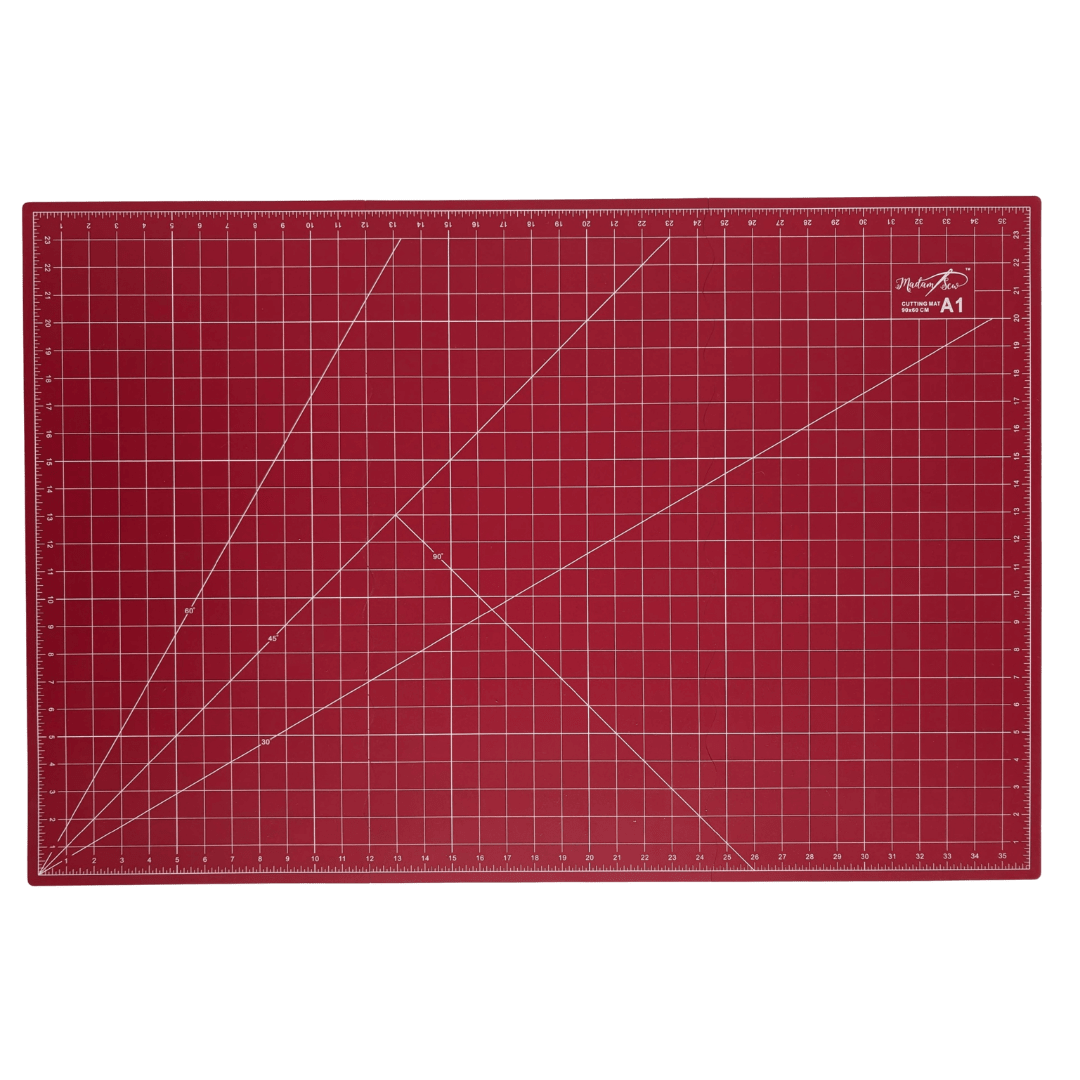 A red A1 cutting mat with white grid lines, measurement markings, and a small white Madam Sew logo in the top right corner, shown flat against a white background.