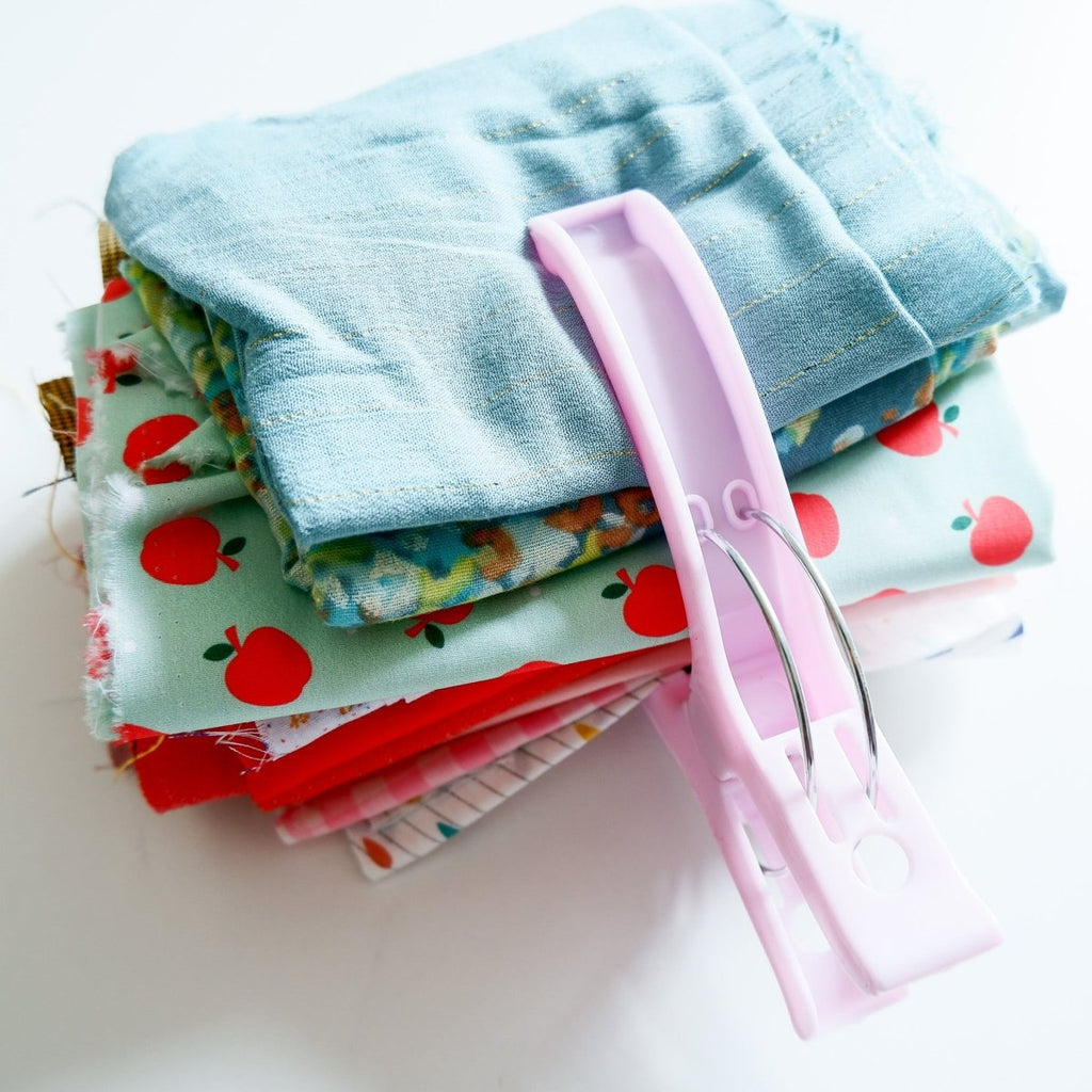 a quilt clamp holding bolts of fabric