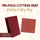 Burgundy tri-fold cutting mat and red rotating cutting mat with grid lines shown together on a leaf-pattern background