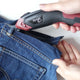 Cutting blue jeans trousers with Electric Fabric Scissors 