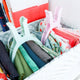 Two clamps holding fabric pieces in a basket