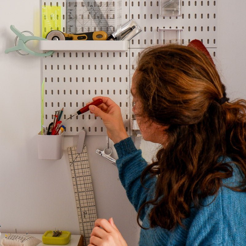 Women using and organizing tools while sewing