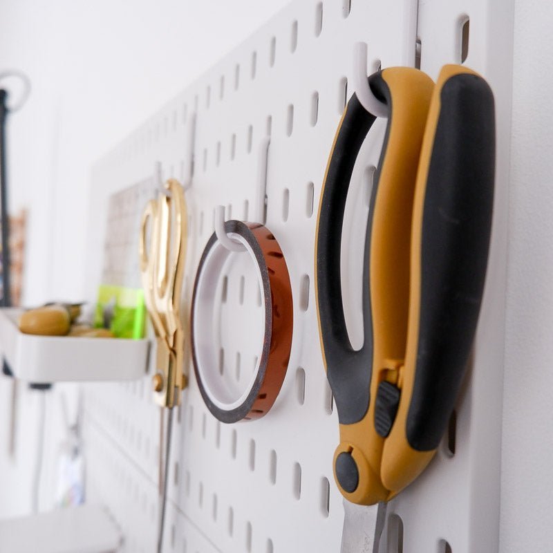 Peg Board hooks holding scissors and tape