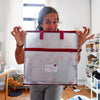 Women holding a Madam Sew Project Bag in a sewing room