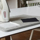 Wool pressing mat on a white table with an iron