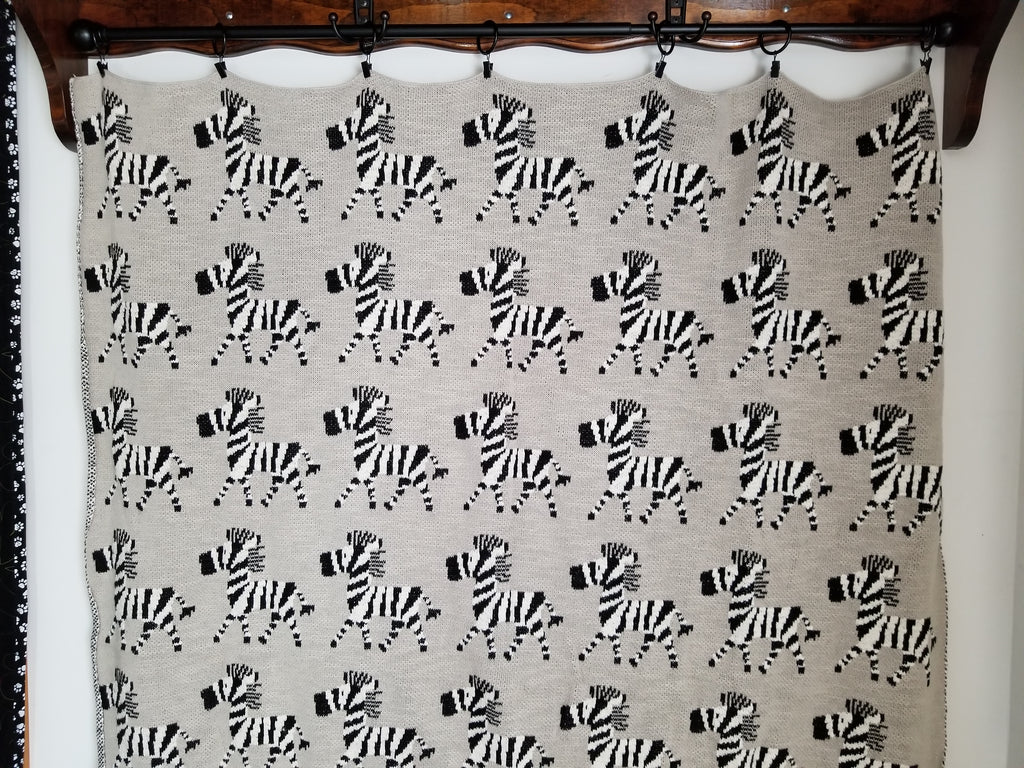 A quilt displayed using Metal Curtain & Quilt Hangers