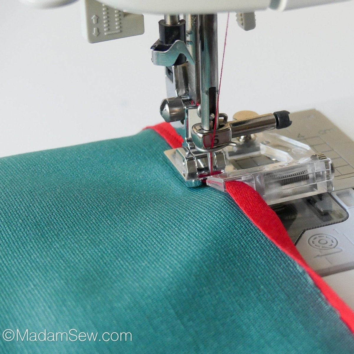 Using the Binder Foot that is included in the 16pc Bias Tape Maker Set to attach bias tape to an item.