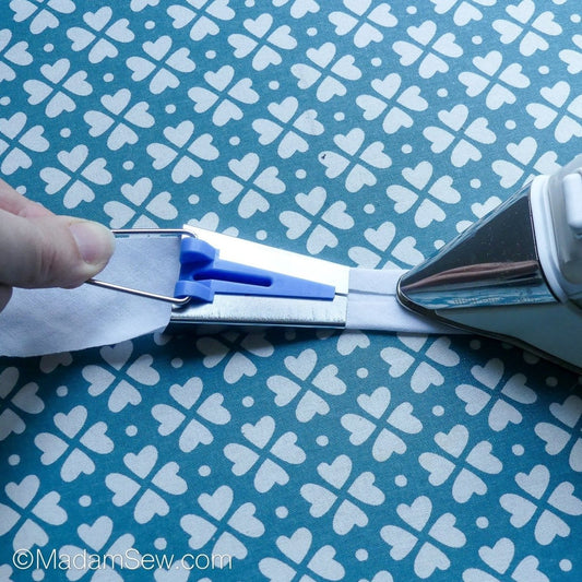 Shows that you can get an iron close to the bias tape maker.