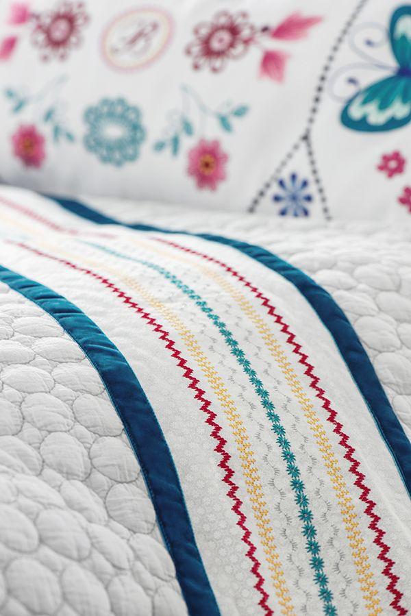 Bedding that has been embellished using the Border Guide Presser Foot.