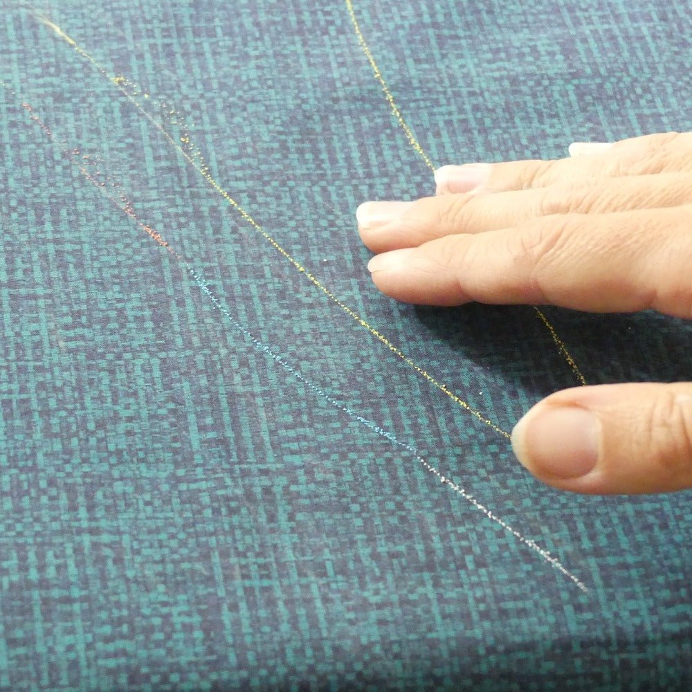 chalk lines of fabric, hand wiping them away
