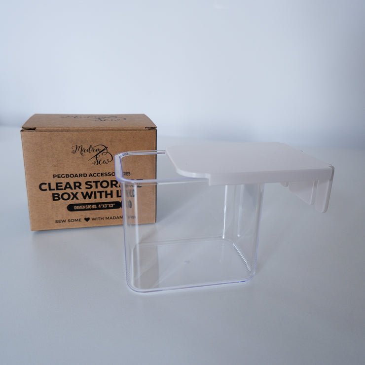 clear plastic box with a white lid and a cardboard box
