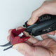 Pulling off the head of the MadamSew Electric Fabric Scissors to replace with spare head.