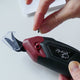 Removing screw from electric fabric scissors