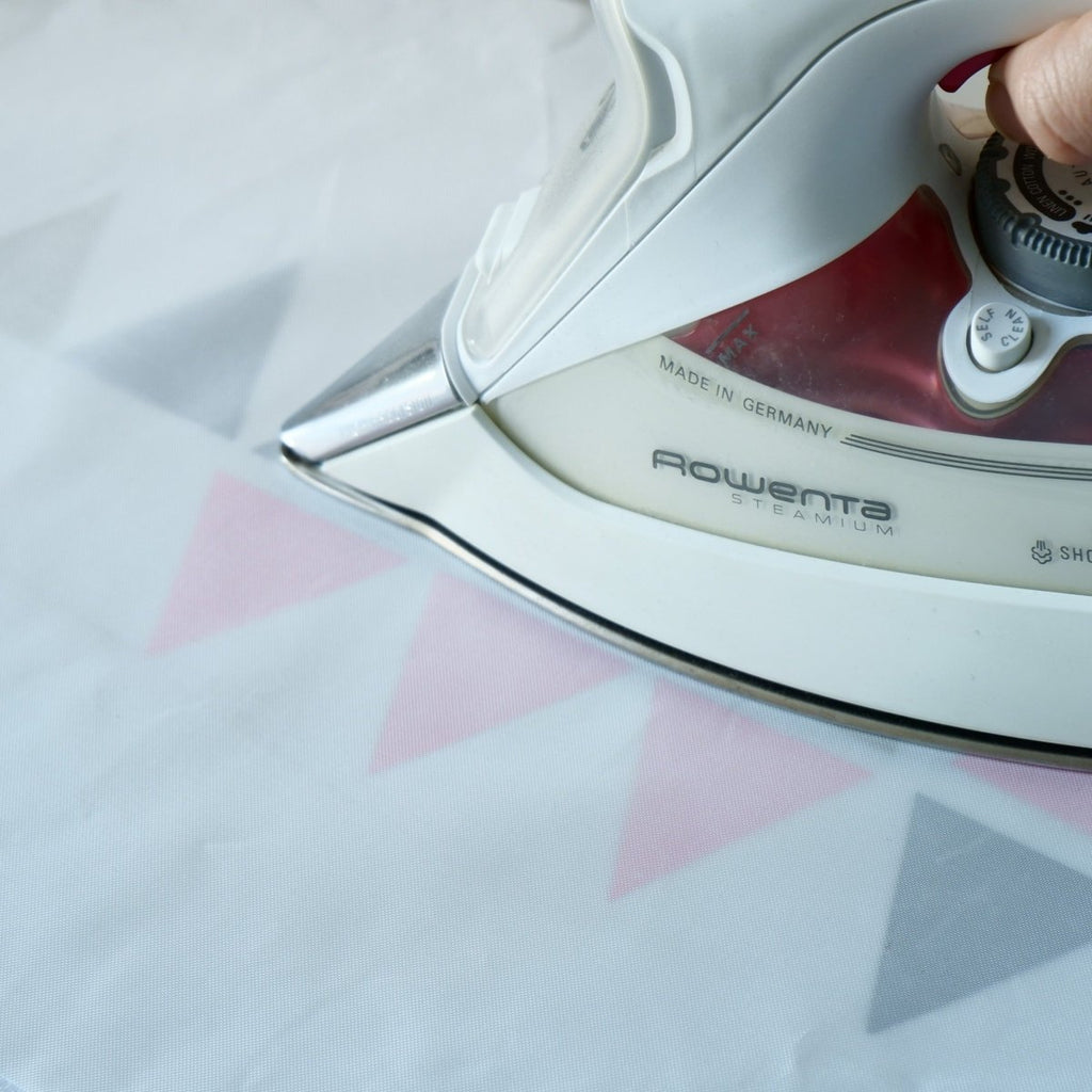 Pressing Heat Transfer Vinyl shapes using a non-stick sheet and iron